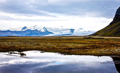 Scenic view of lake and mountains against sky