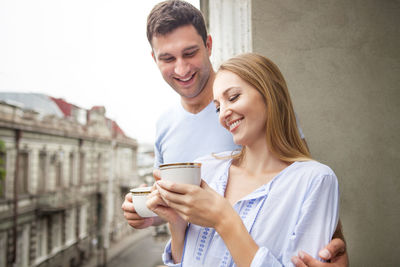 Happy young man holding coffee cup