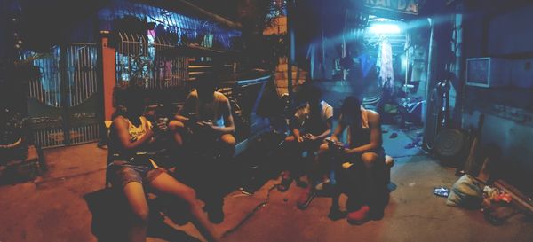 People standing in illuminated room