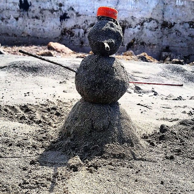 land, art and craft, creativity, no people, representation, day, beach, sand, nature, toy, human representation, sunlight, solid, shadow, craft, focus on foreground, outdoors, stack, winter, pebble, warm clothing