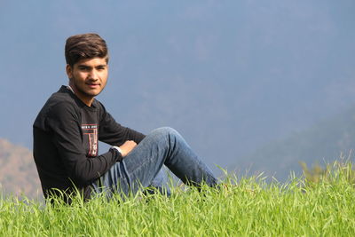 Full length of man on grass against sky