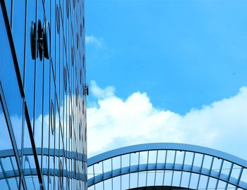 Low angle view of skyscraper against blue sky