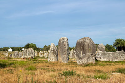 Stone wall on field against sky