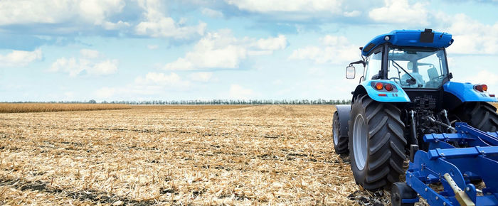 Tractor on field against sky