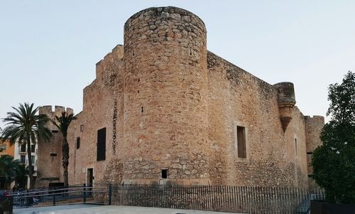 Low angle view of old building against clear sky