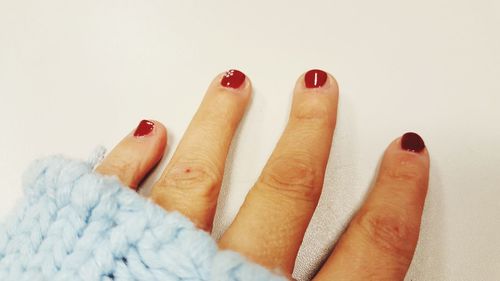 Close-up of woman hand against white background