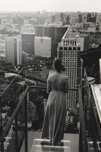 Rear view of woman looking at city buildings