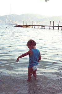 Boy standing in water