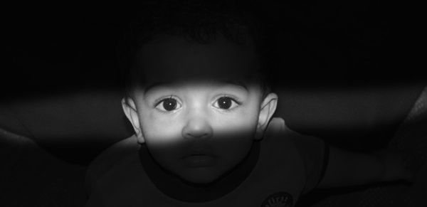 Portrait of cute boy in dark