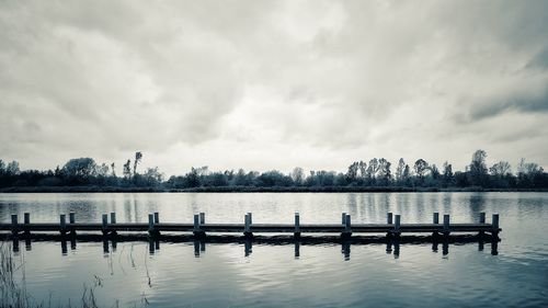 Pier on lake against sky