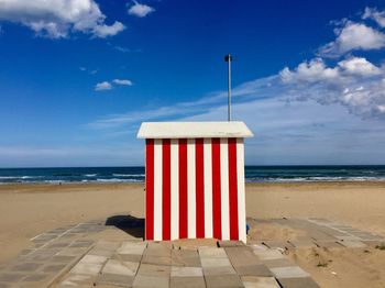 Lifeguard hut on beach against sky