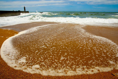 Scenic view of beach against sky