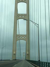 Metal bridge against sky in city