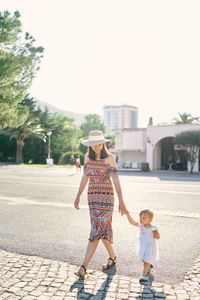 Full length of women walking against sky