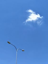 Low angle view of street light against blue sky