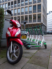 Motor scooter on street against buildings