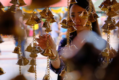 Close-up of woman looking at bells at store