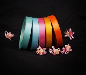 Close-up of pink flowers on table against black background