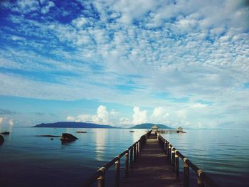 Pier over sea against sky