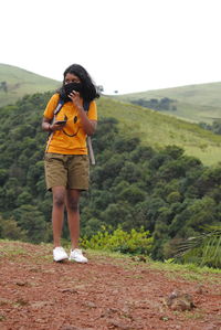 Full length of woman standing on mountain