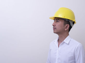 Portrait of man wearing hat against white background