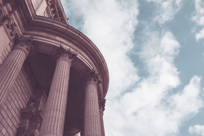 Low angle view of building against cloudy sky