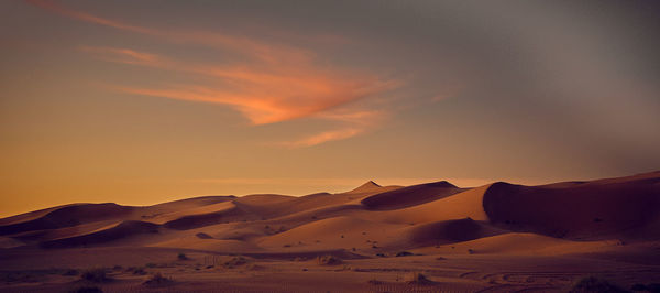 Scenic view of desert against sky during sunset