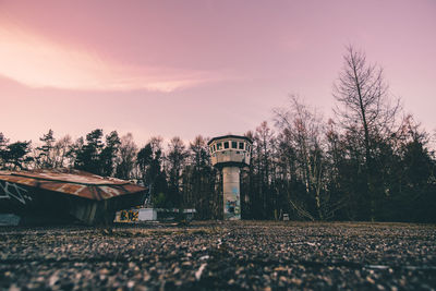 Water tower against sky during sunset