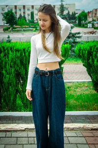 Young woman standing on footpath