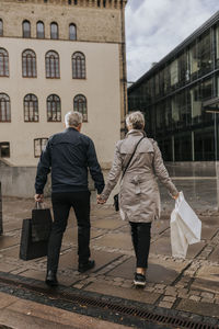 Couple walking in city with shopping bags