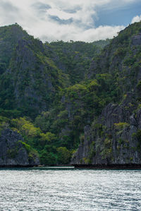 Scenic view of sea and mountains against sky