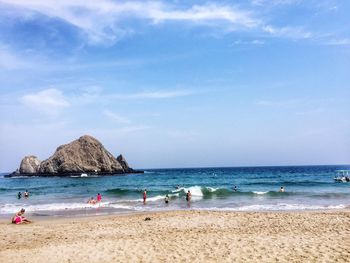 Scenic view of beach against blue sky