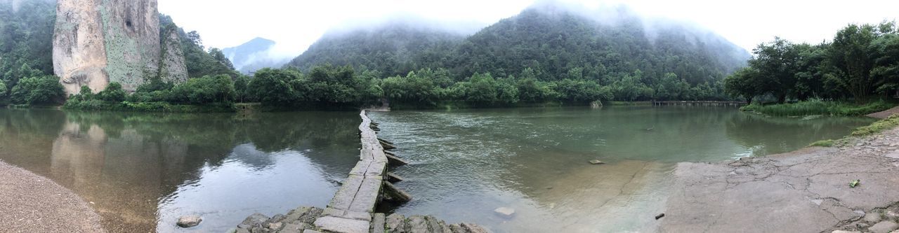 water, tranquility, tranquil scene, mountain, reflection, lake, scenics, beauty in nature, nature, tree, idyllic, sky, non-urban scene, river, rock - object, day, remote, mountain range, outdoors, calm