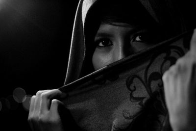 Close-up portrait of young woman wearing scarf