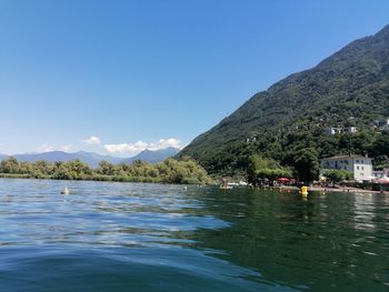 Scenic view of sea and mountains against sky