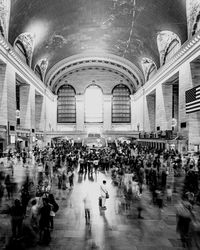 Group of people walking at railroad station