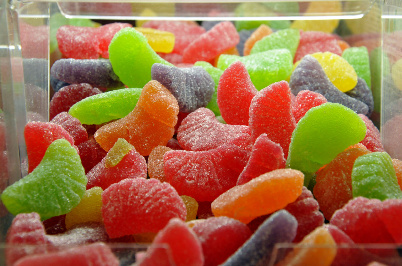 gummi candy, gumdrop, candied fruit, food, food and drink, confectionery, wine gum, sweet food, dessert, sweet, fruit, freshness, produce, candy, large group of objects, multi colored, abundance, variation, no people, healthy eating, sweetness, indoors, close-up, still life, temptation, retail, sugar, for sale, wellbeing, strawberry, dish, berry, cuisine, store, watermelon, selective focus