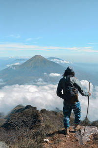 Rear view of man standing on mountain