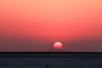 Scenic view of sea against romantic sky at sunset