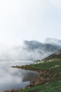 Scenic view of waterfall against sky