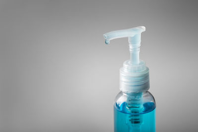 Close-up of glass bottle against blue background