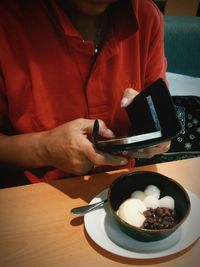 Hand holding food on table