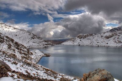 Scenic view of mountains against cloudy sky