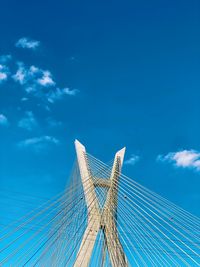 Low angle view of bridge against blue sky