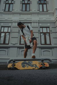 Low section of man jumping in city