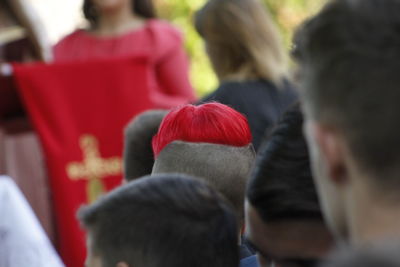 Man with dyed hair standing in crowd