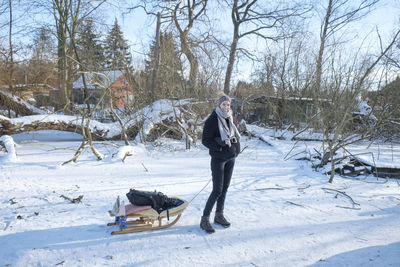 Man on snow field against trees during winter