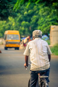Rear view of person on road in city