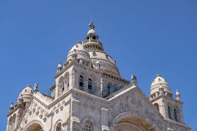 Low angle view of building against clear blue sky