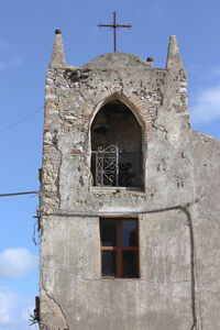 Low angle view of bell tower against sky